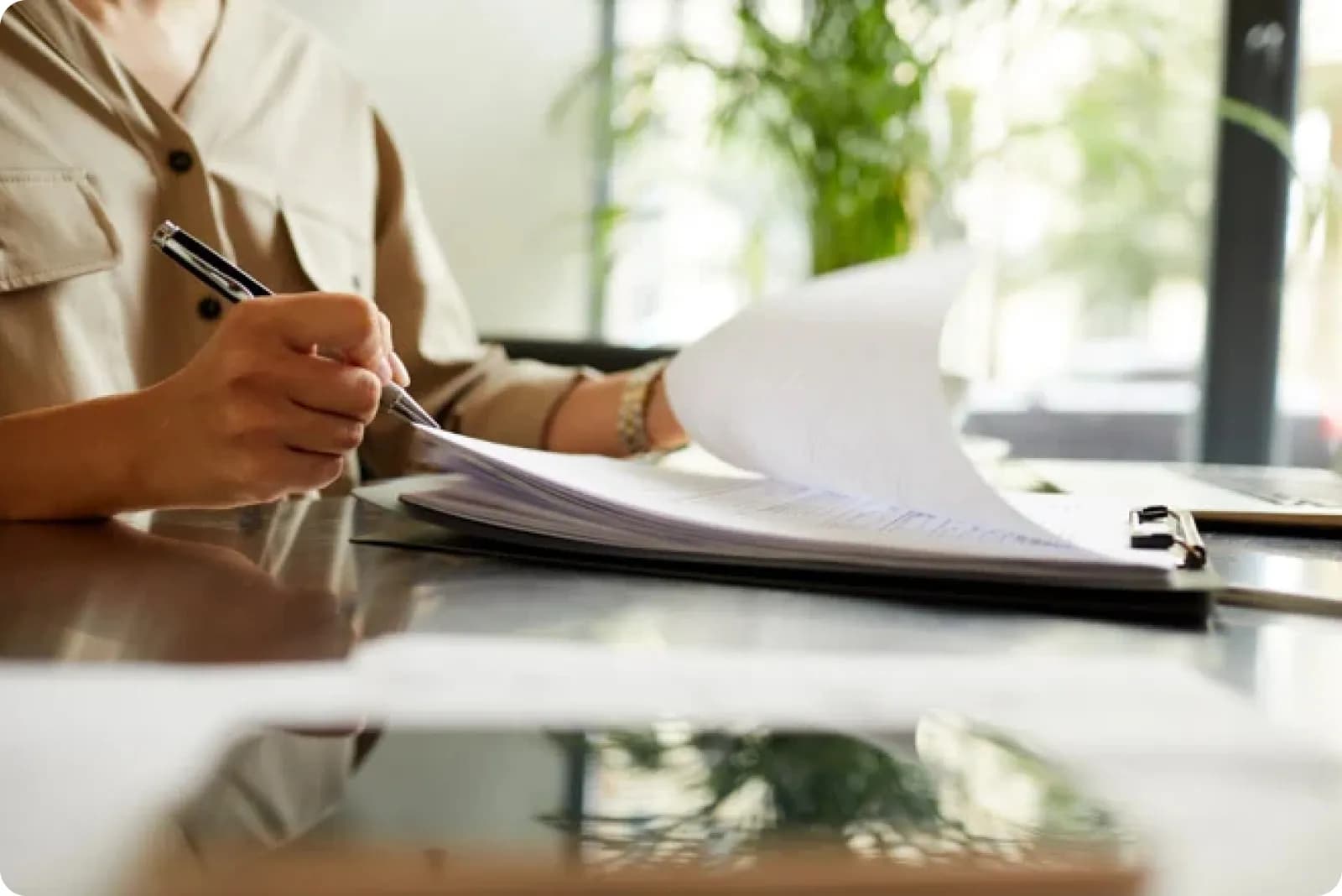 Woman signing some company documents